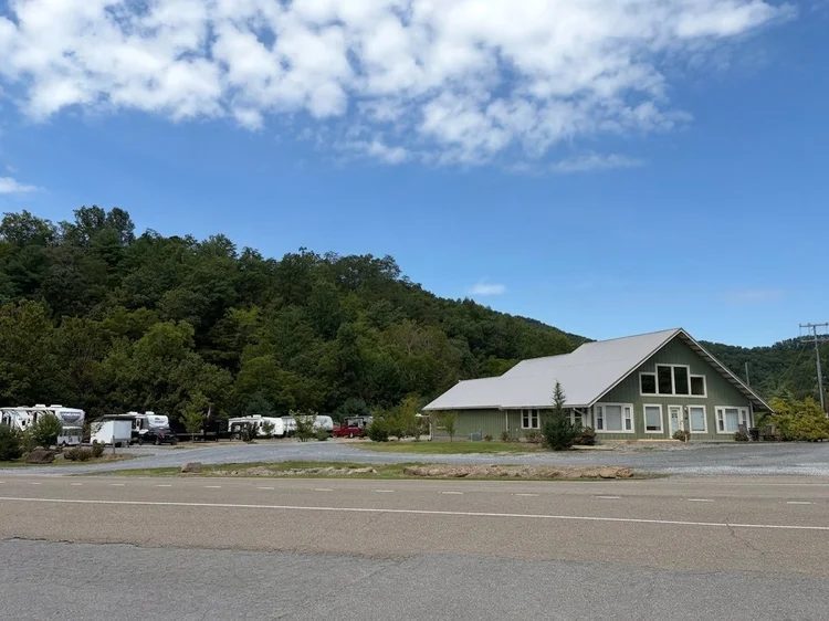 The office and laundry building with green siding, beside the RV lots